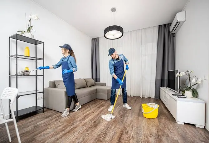 Cleaners deep cleaning a living room