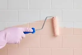 Paint roller applying a fresh coat to a wall